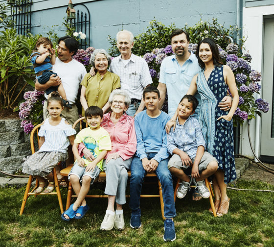 Portrait of multigenerational family in backyard garden on summer evening