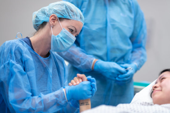 Doctor holding patient's hand before surgery